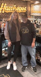 Owner's of Coach's Corner standing by the bar