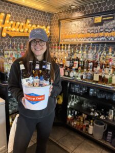 One of the Coach's Corner bartenders holding a bucket of beer