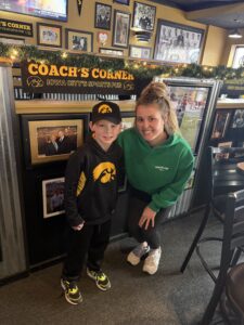 One of the Coach's Corner owners with a smallyoung boy guest