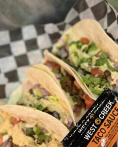 4 beef and chicken tacos and packets of taco sauce