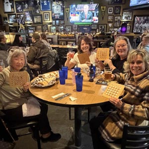 Group of 4 women playing bingo at Coach's Corner