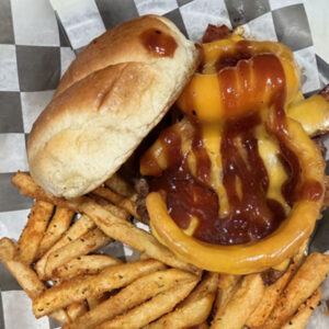 Coach's Corner Brands Takedown Burger topped with onion rings, cheddar cheese, and barbeque sauce served on a bun with French fries