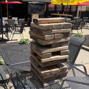 Stack of jumbo Jenga blocks on a table on the Coach's Corner patio